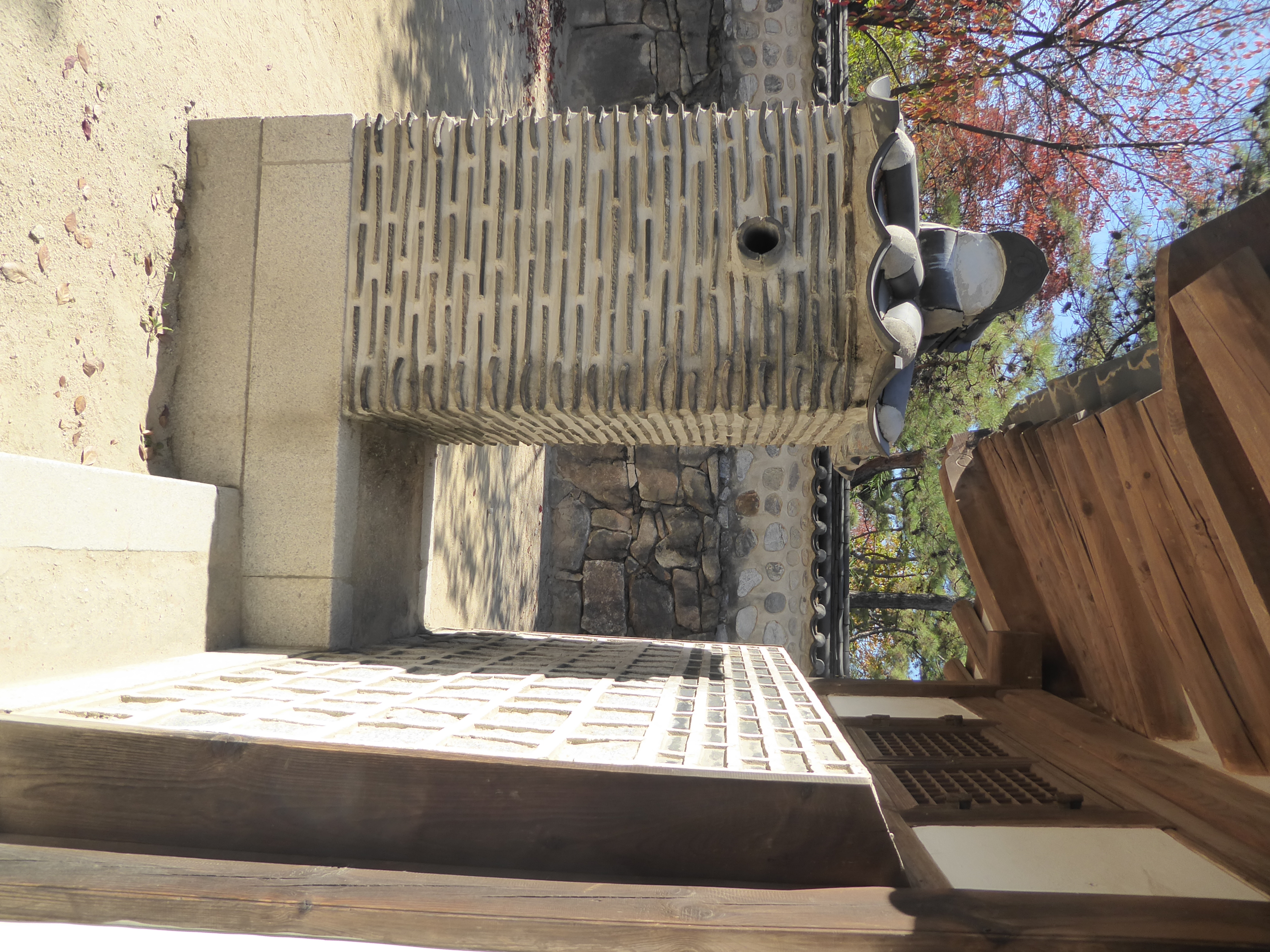Puzzled? It's a chimney for an ondol or underfloor heating system; the fireplace is on the opposite side of the house.