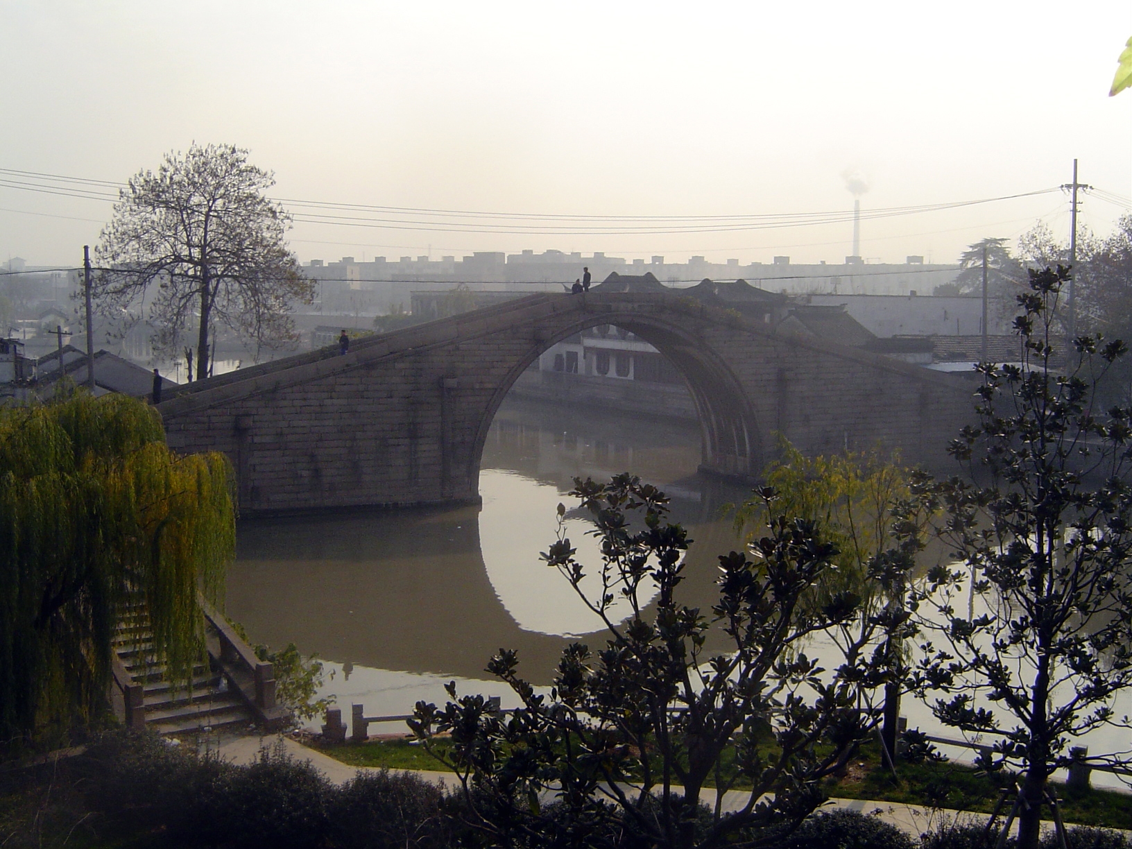 Wumen. The moat here sends off a branch to the left, where it flows through a water gate in the city wall. The city is fifty miles from the