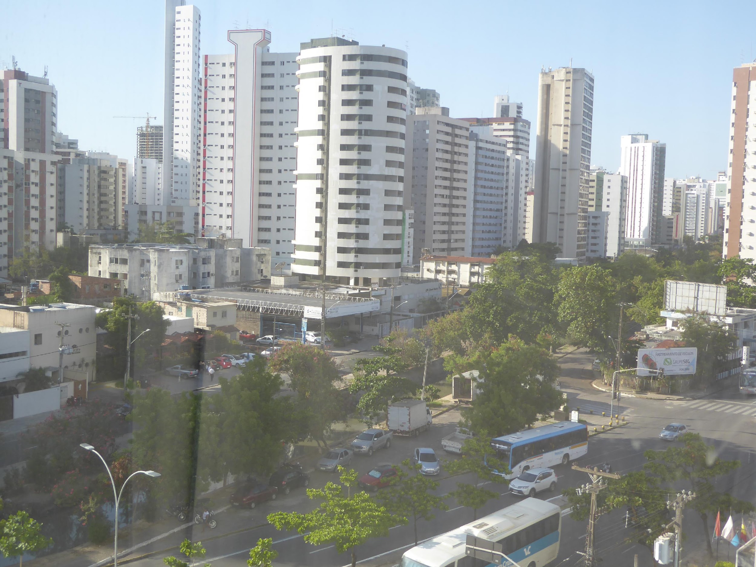 The view through an unfortunately sealed hotel window on Domingos Ferreira Avenue, a main street running parallel to the beach. Never forget