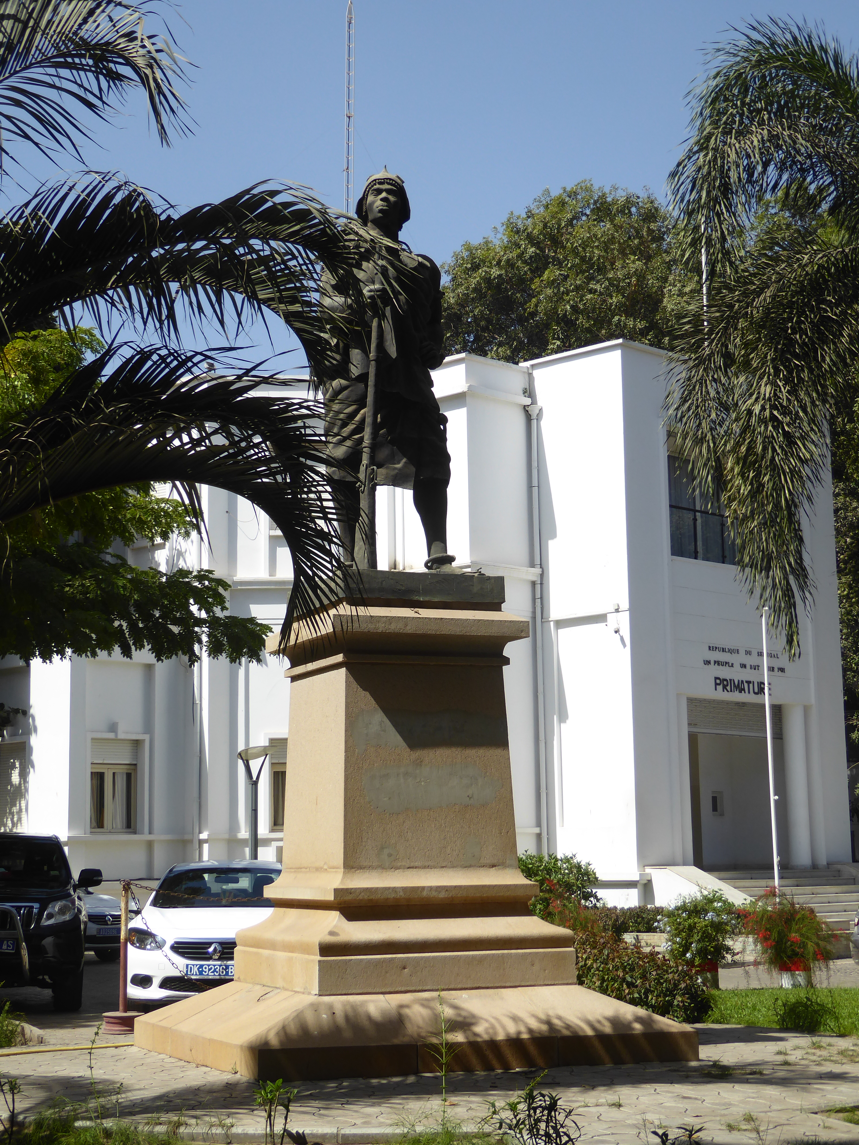 Another Senegalese rifleman or tirailleur sits outside the Primature or prime minister's office and faces the presidential palace. Photograp