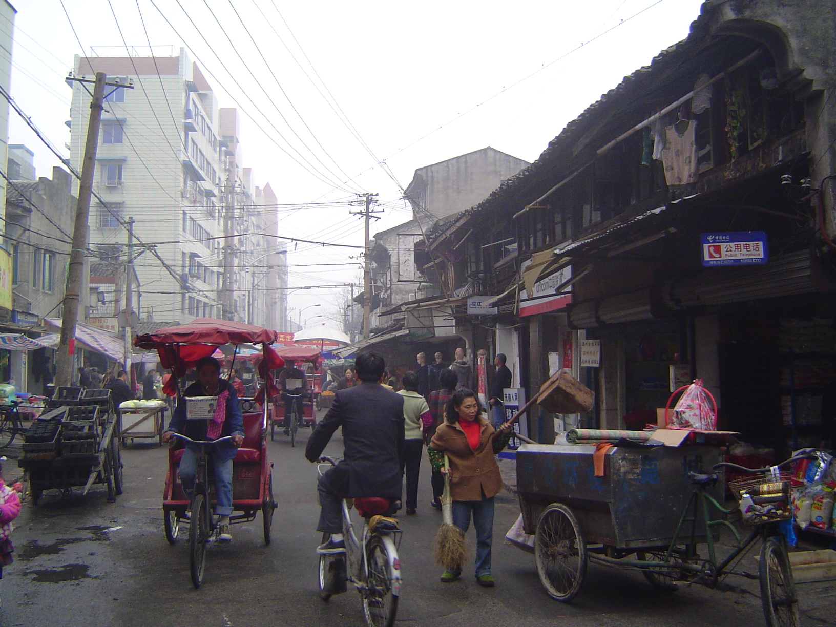 Cycle-rickshaws; charcoal briquets on the left.