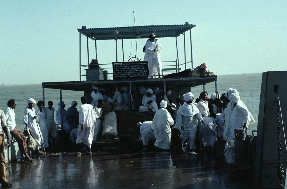 A ferry crosses the broad reservoir formed on the White Nile by the Jebel Aulia Dam, upstream from Khartoum but built by and for Egypt. The