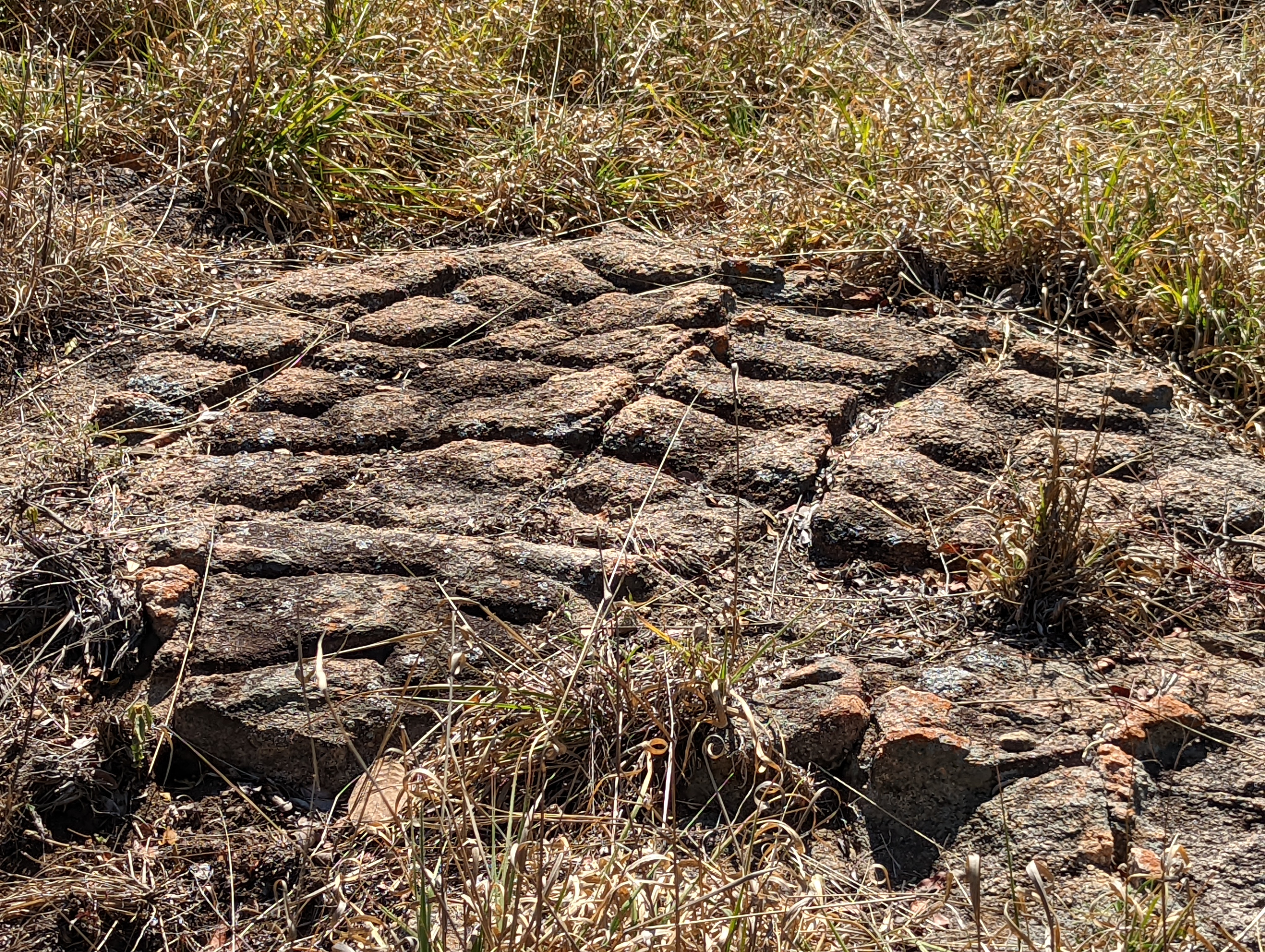 Outside the wall, there's a bit of bedrock sliced like this. Ideas?