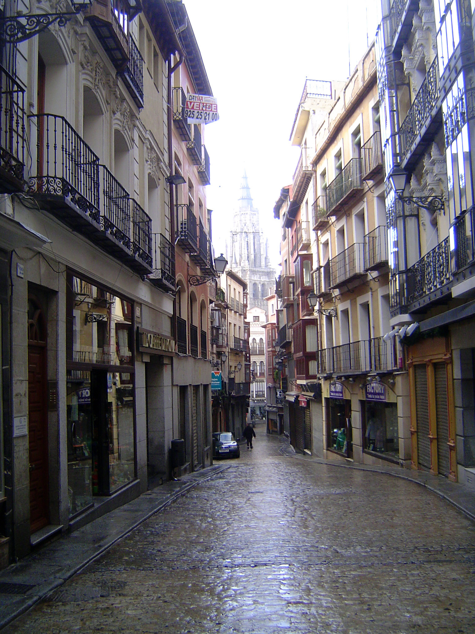 Ford writes: "Now a long and almost the only widish street in Toledo leads to the Gothic cathedral." Its spire looms early on a wet morning.