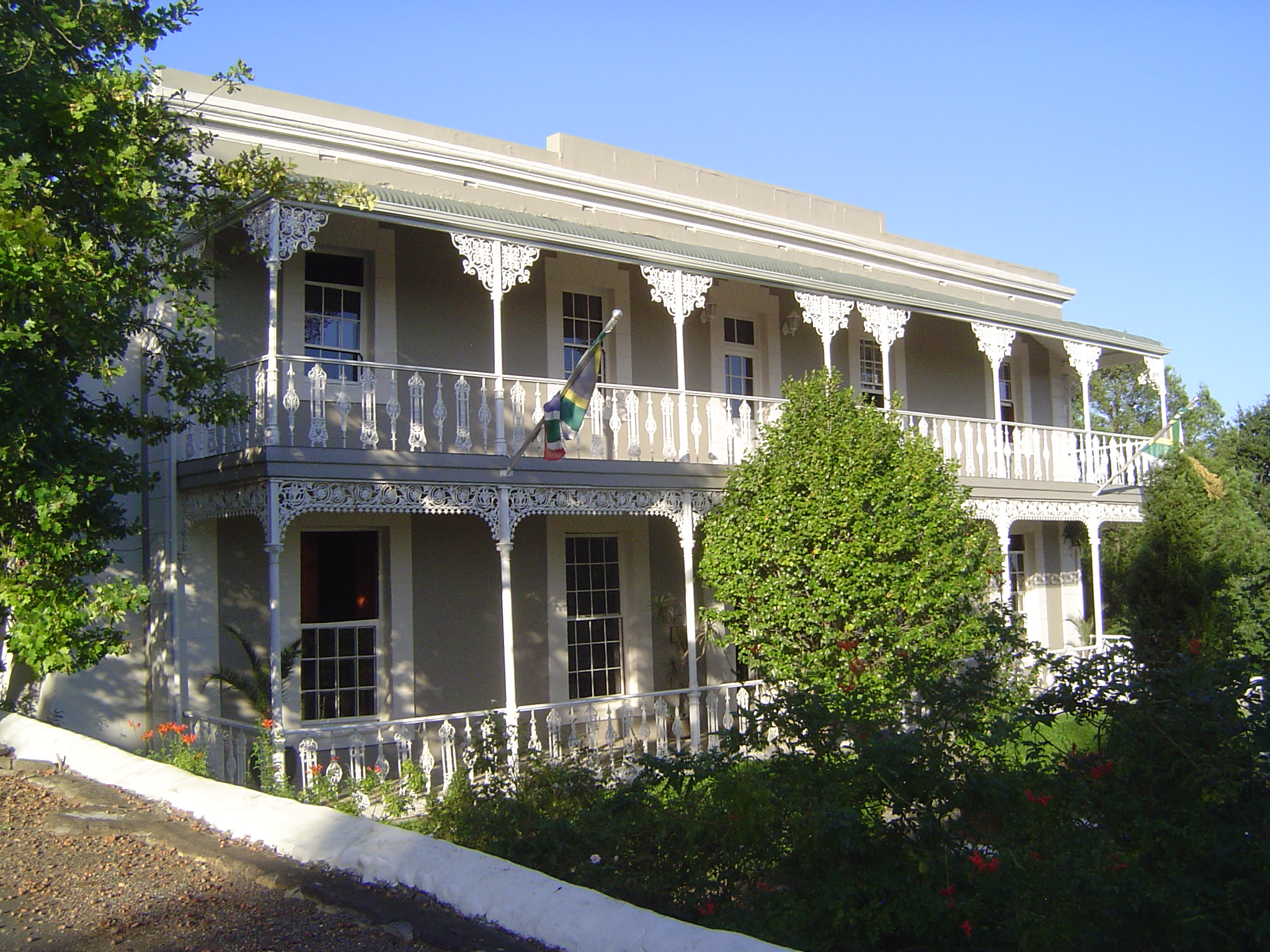 No concessions here. The house was built in 1853 in a simple Georgian form; the verandas and metalwork were added after 1900. For a time it