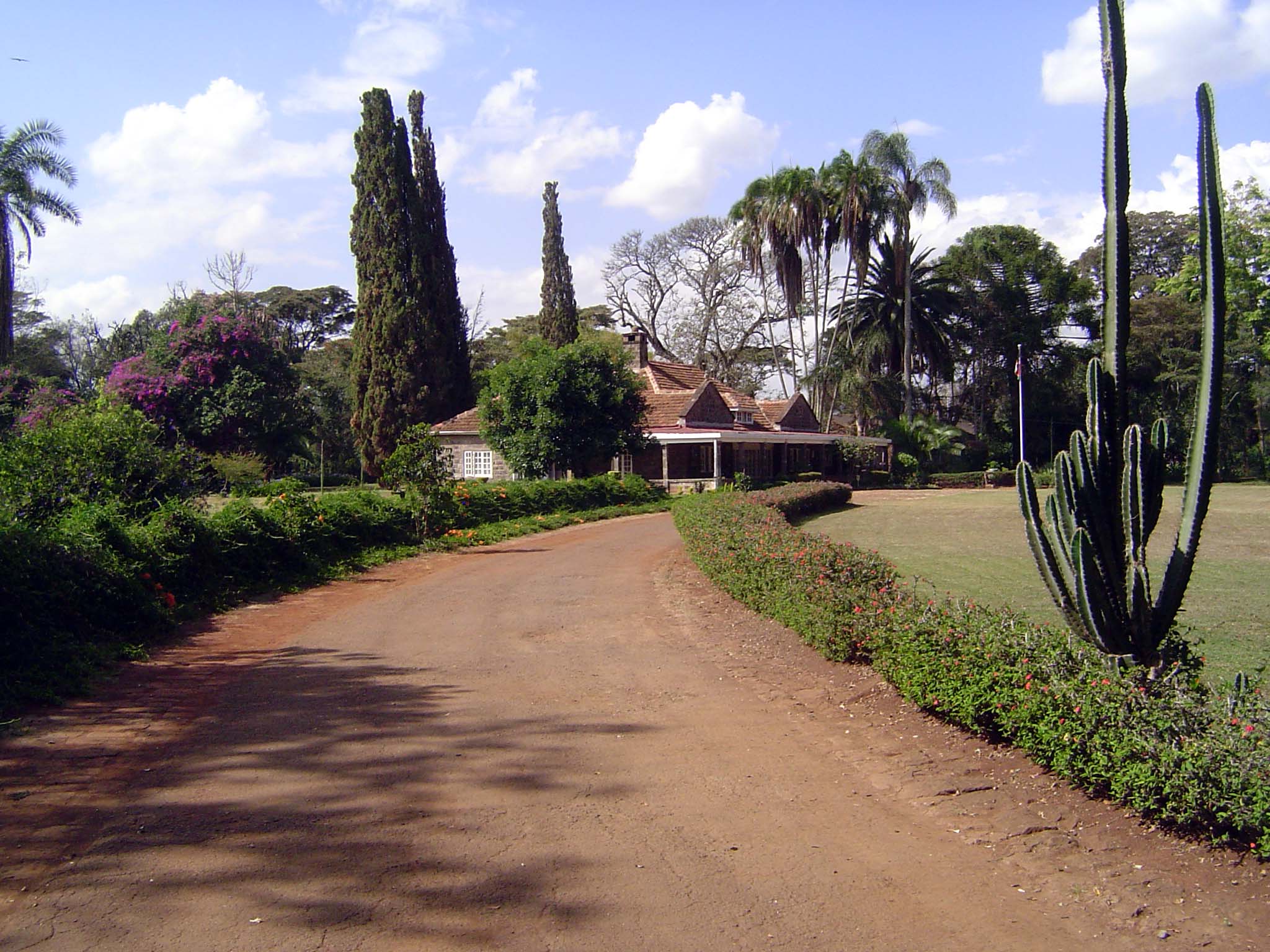 Just shy of ten miles southwest of downtown Nairobi, in the district now known as Karen, the traffic drops off and the house comes into view