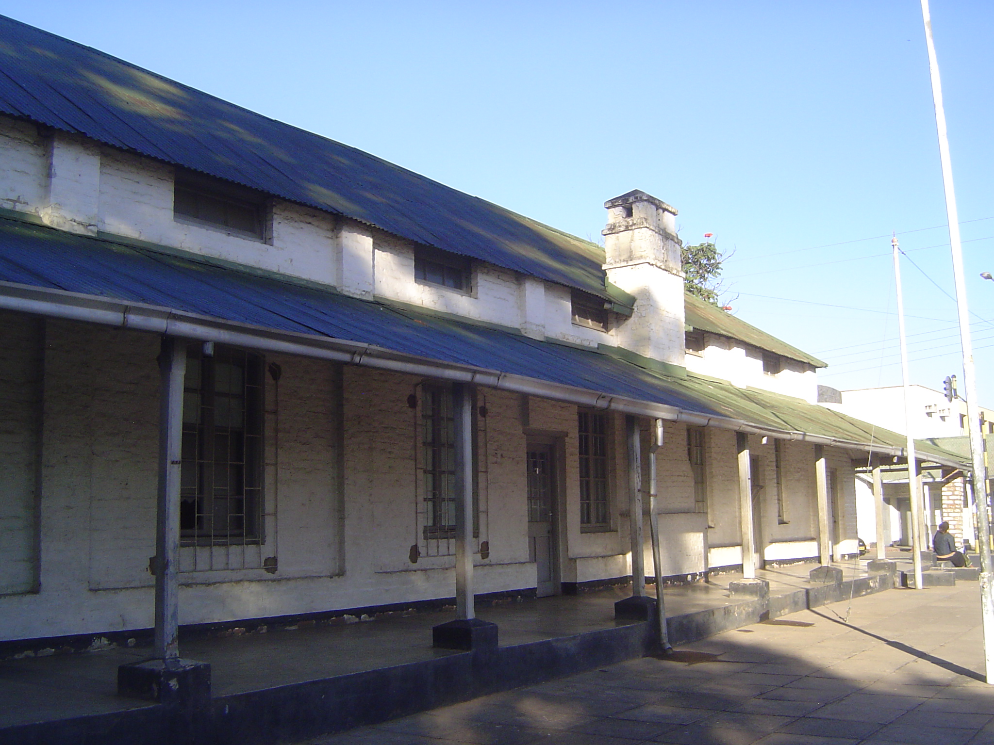 The boma or government quarter was less than a mile away. It was very modest, with everything one-story, red-brick, and with metal roofs pai