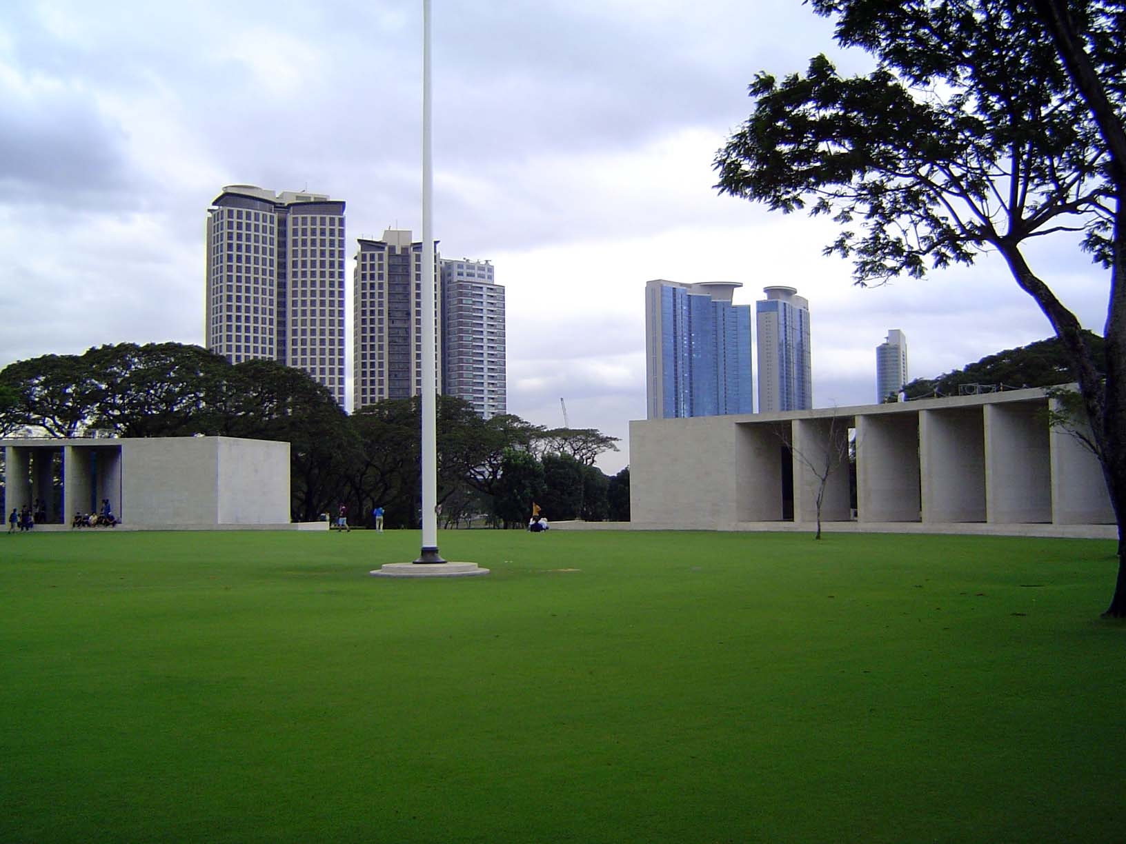 In the center and with Bonifacio Global City in the background, there's a monument consisting chiefly of two travertine hemicycles around a