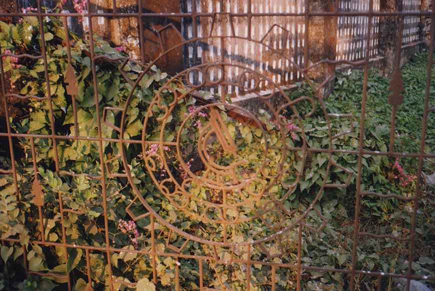 A side gate to the same school: the microscope in wrought-iron is a fine symbol of the missionaries' hopes of introducing science to Burma.