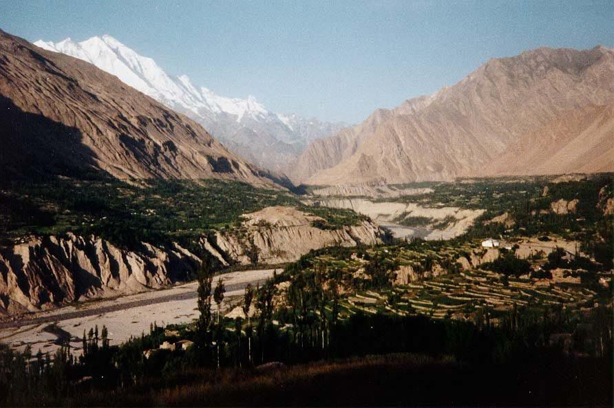 The Hunza River flows south past irrigated terraces in the center of Hunza. Rakaposhi is the huge mountain in the background; the sore thumb