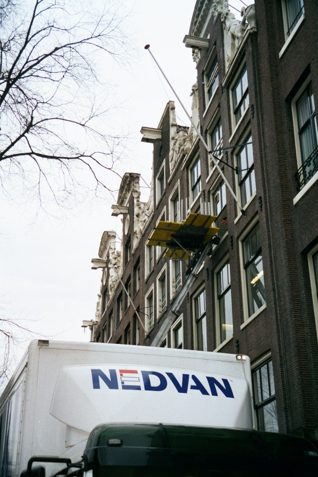 Just in case you wonder how movers operate these days, now that the old block-and-tackle rigs up there on those neck gables are ornamental.