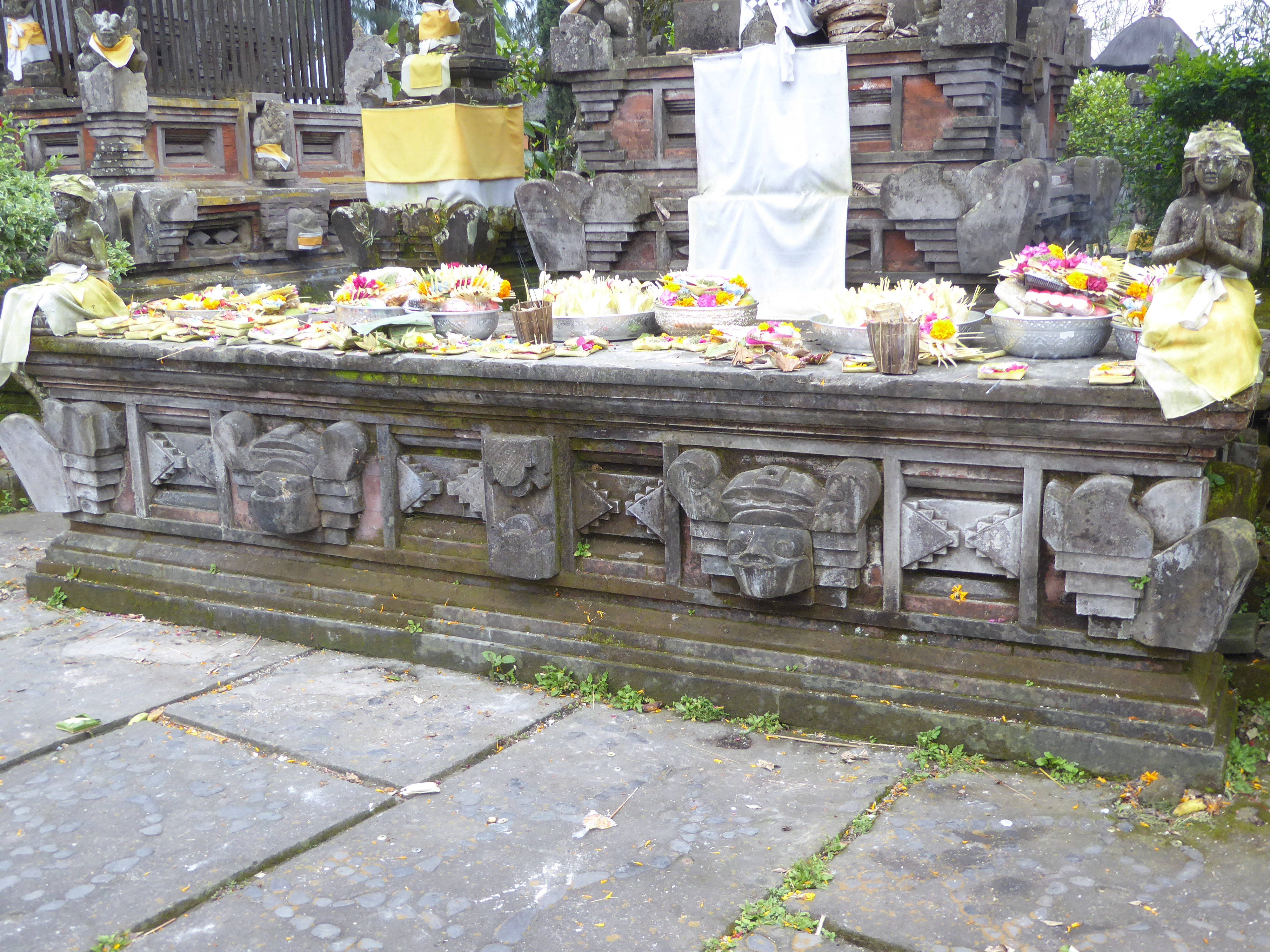 Ritual complete, offerings are left behind. The yellow wrapping signifies a holy presence.