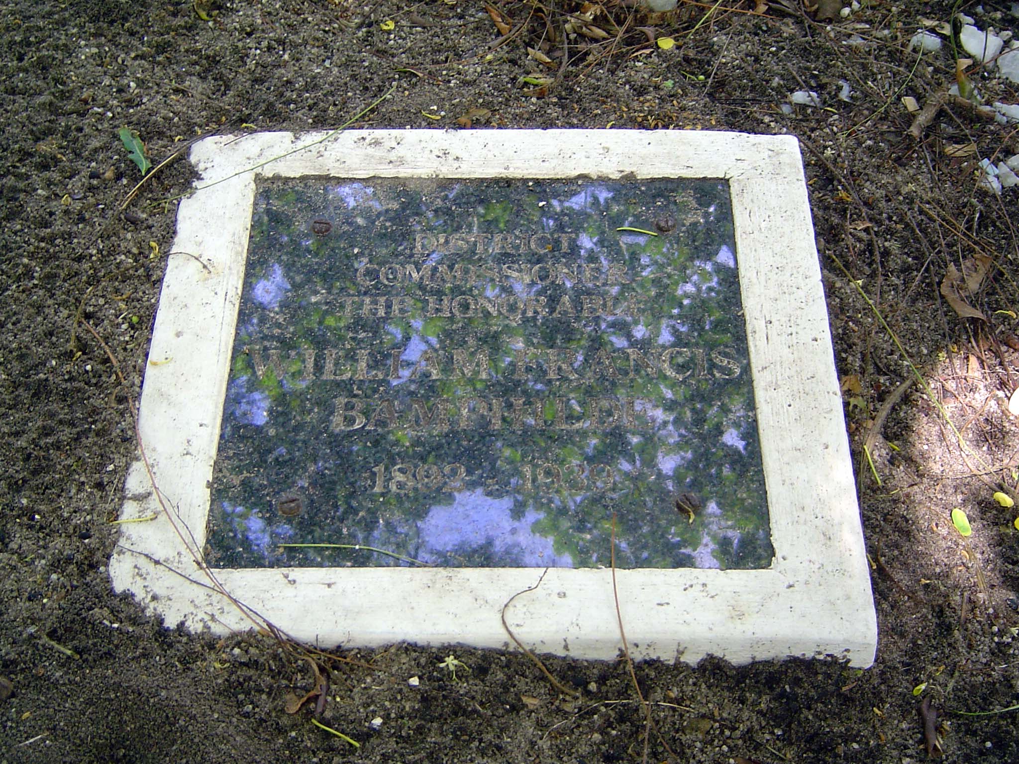 The stone reads: "District commissioner the Honorable William Francis Bamphylde, 1892-1930." It is said that he shot himself after learning