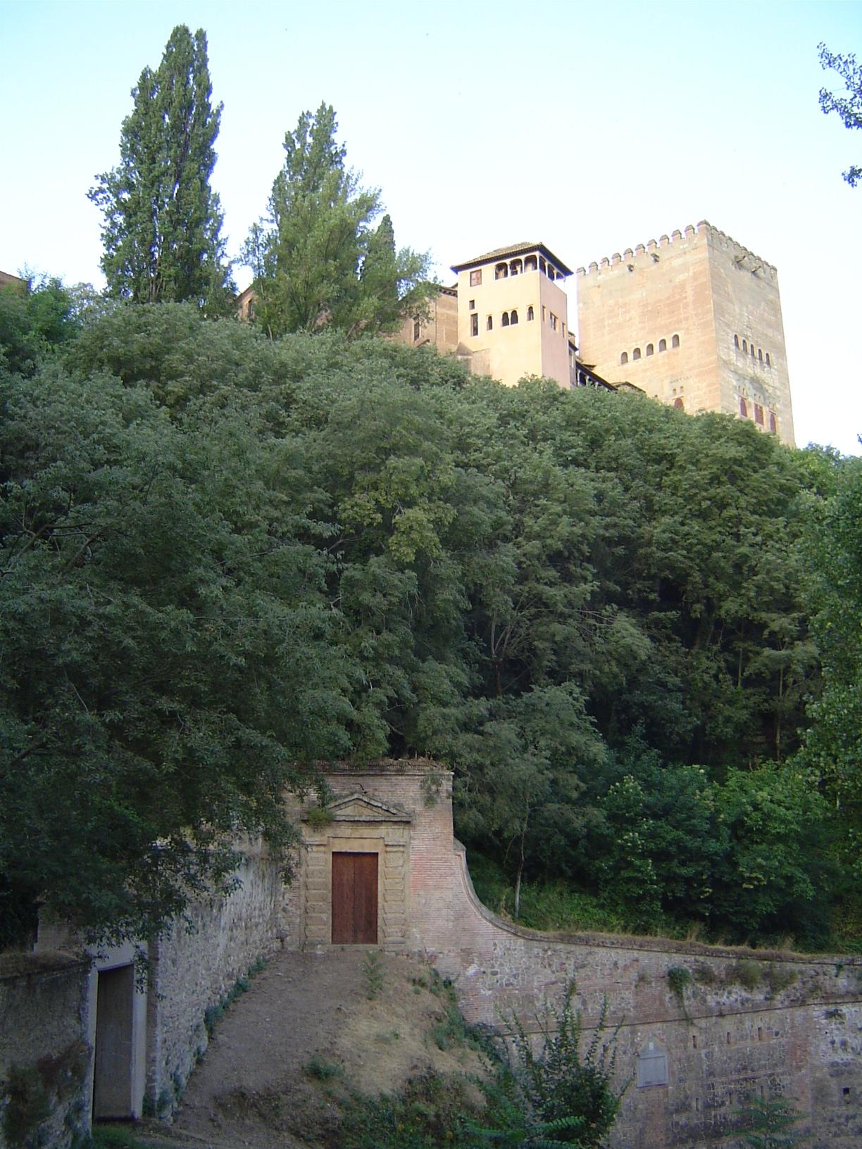 Looking up at the palaces from the slope at the foot of Lindaraja and the Tower of Comares. Numerous old entrances, like the one shown here,