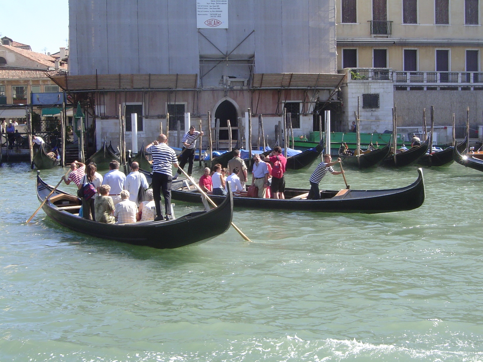 Ferries still cross the Grand Canal. Most passengers stand, and habitual strap-hangers have to watch their balance.