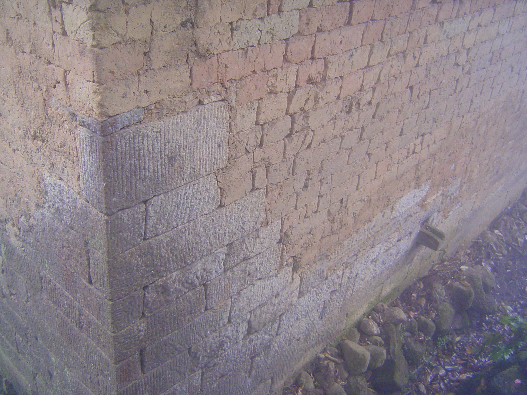 At the base, and especially at the corners, stone is used to resist erosion. Locally, nobody builds this way anymore.