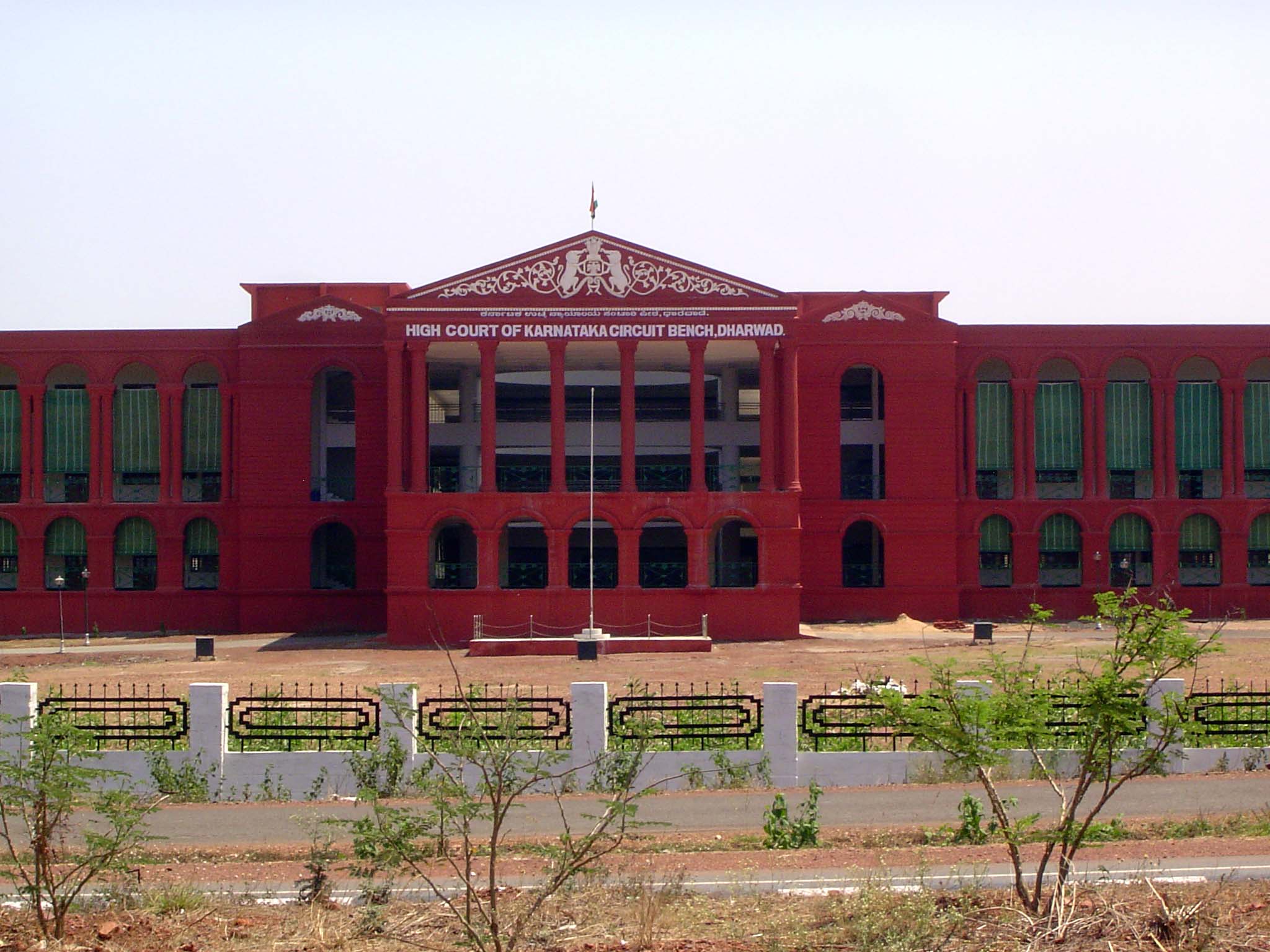 A courthouse in grand isolation along the highway. If judges can wear wigs, then courthouses may as well dress up as Greek temples. The use