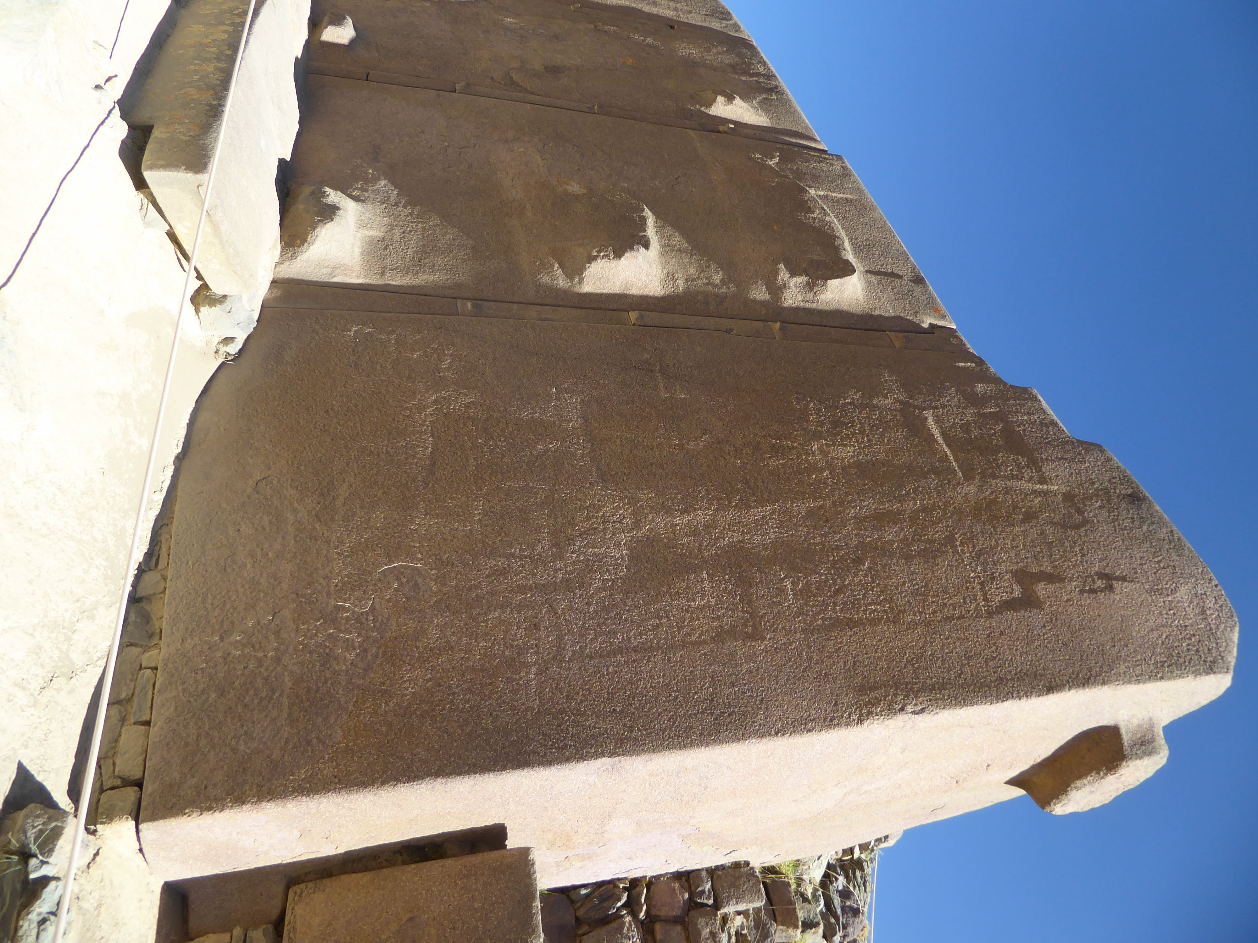 The tenon at the upper right suggests that the blocks are locked together, though it's hard to verify this. Why the blocks have similar bulg