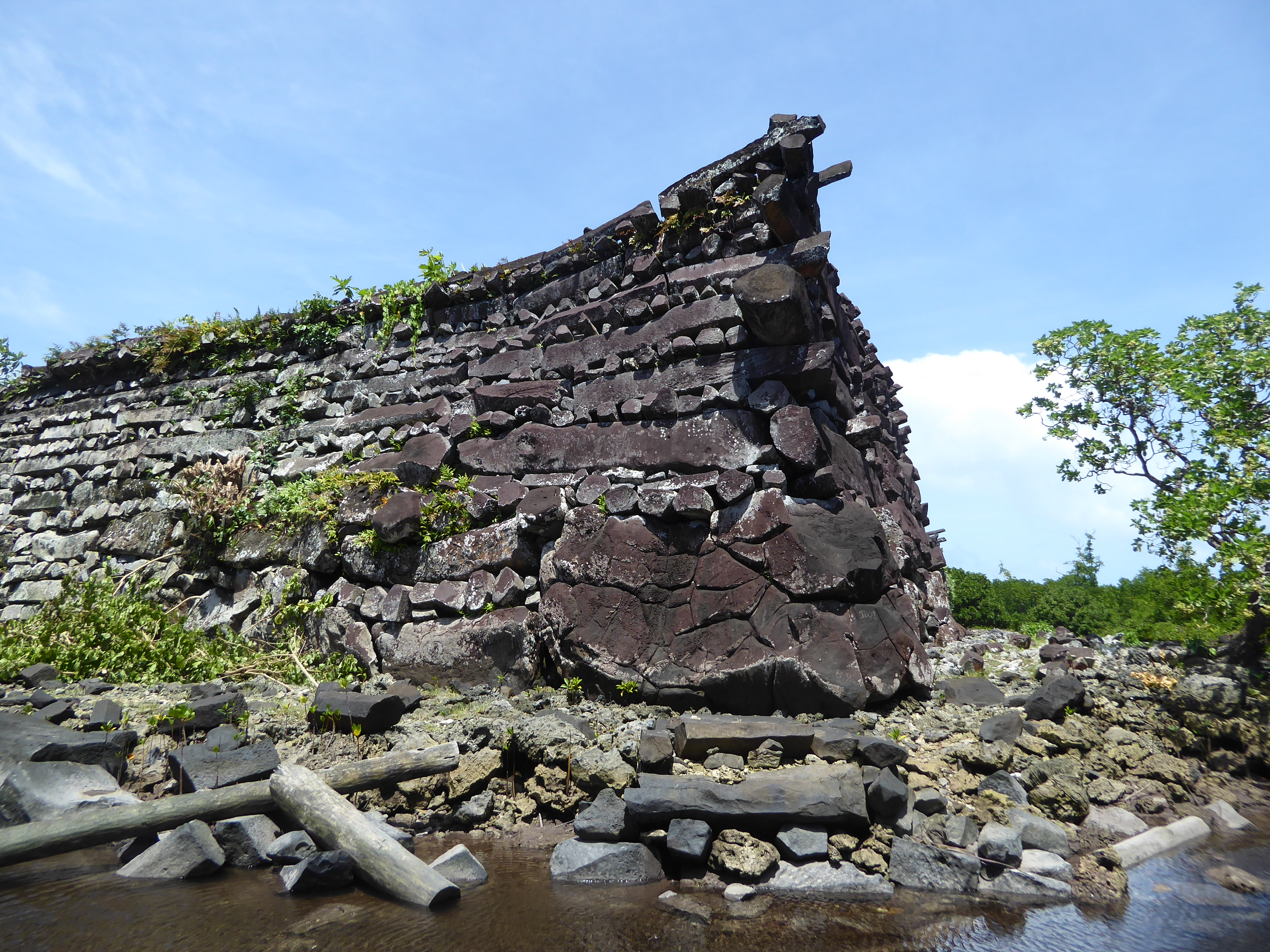 The path makes its way around the southeast corner of the enclosure. We're stepped into the water to get a good look at the wall. The corner
