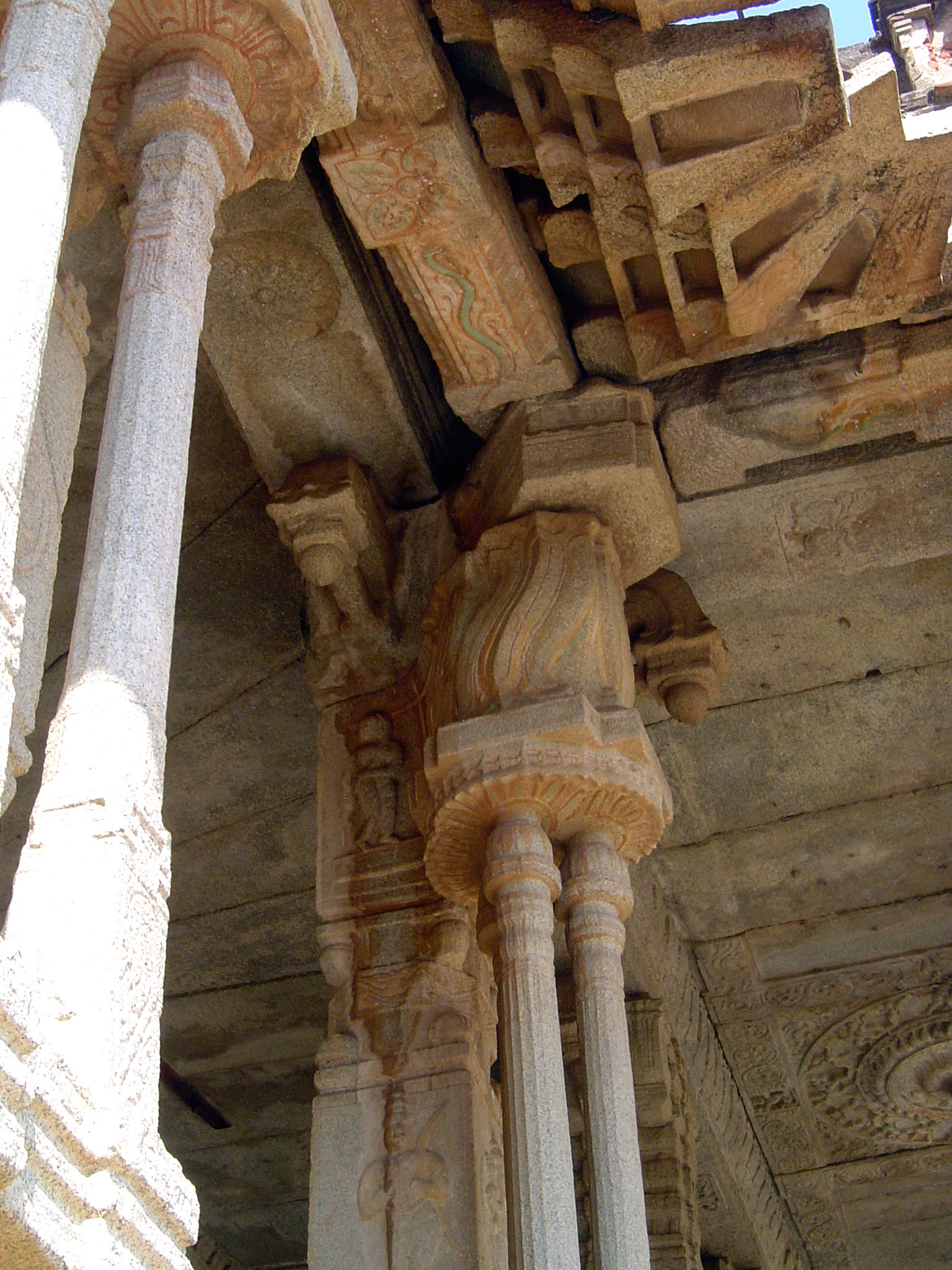 Cut-out colonettes support a flame-like capital. The roof has evidently shifted.