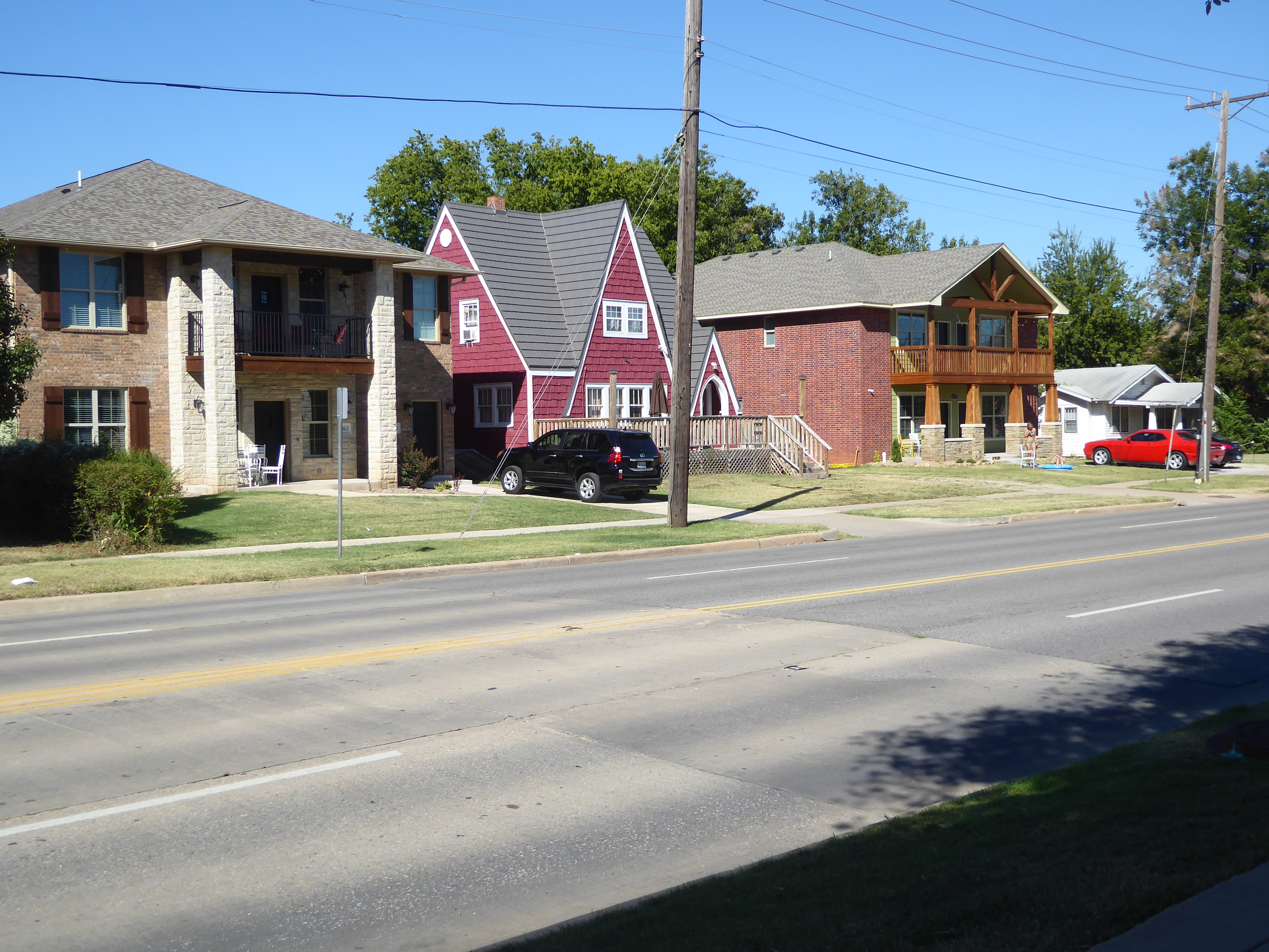 Here two duplexes squeeze into the spaces between older homes. See the odd red one?