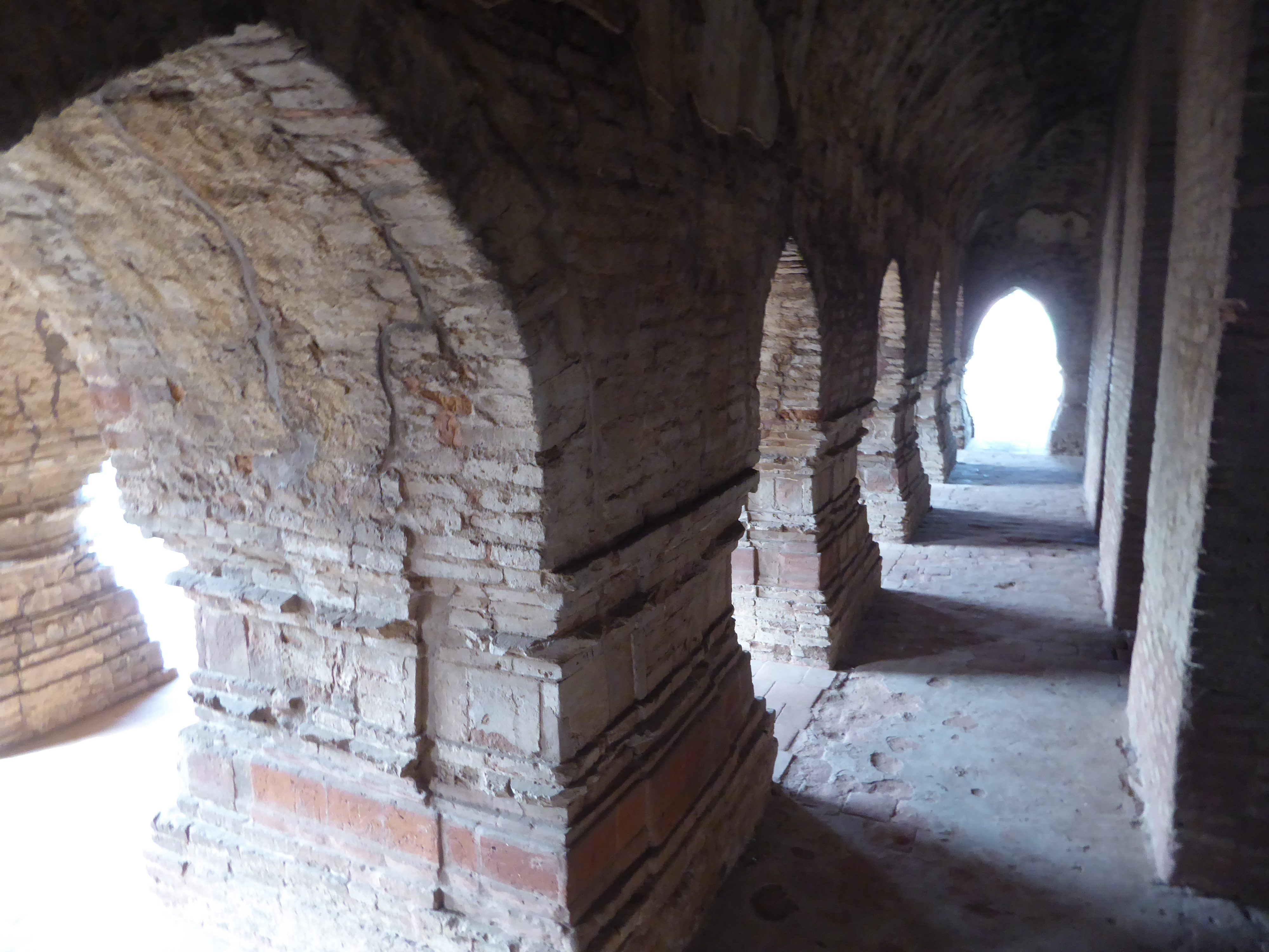 The structure consists of a central pyramid rimmed by three rings of arches, ten in the outer, five in the inner, eight in between. The arch