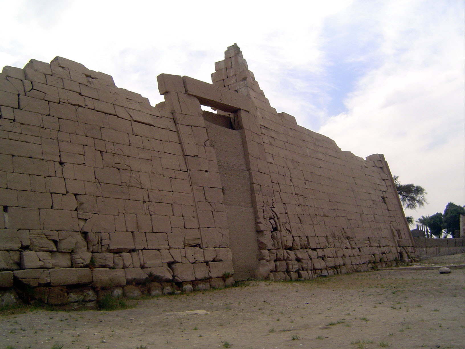 The first pylon—its entrance blocked—is made of sandstone instead of the usual mud brick. Internal staircases at either end lead to the top.