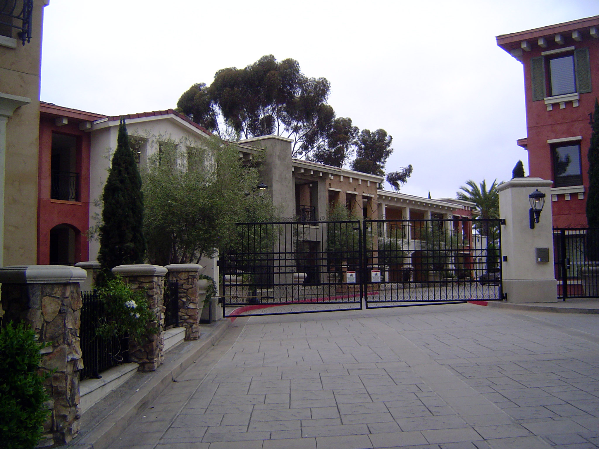Across the street, a different option: a gated community swept clean of trash and riffraff.