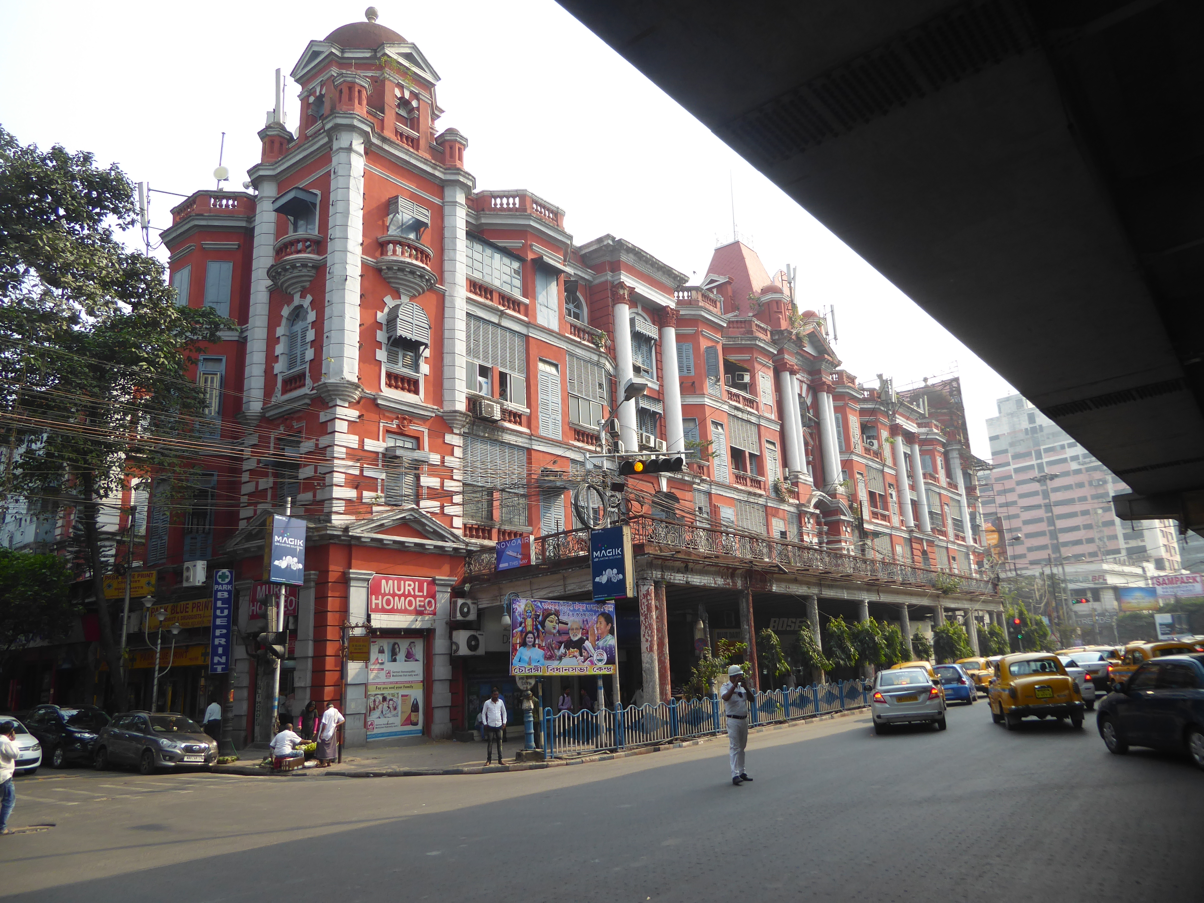 Here's a bit of the flyover for you, but the building whose tenants get a first-rate view of it is Chowringhee Mansions from 1907, a project