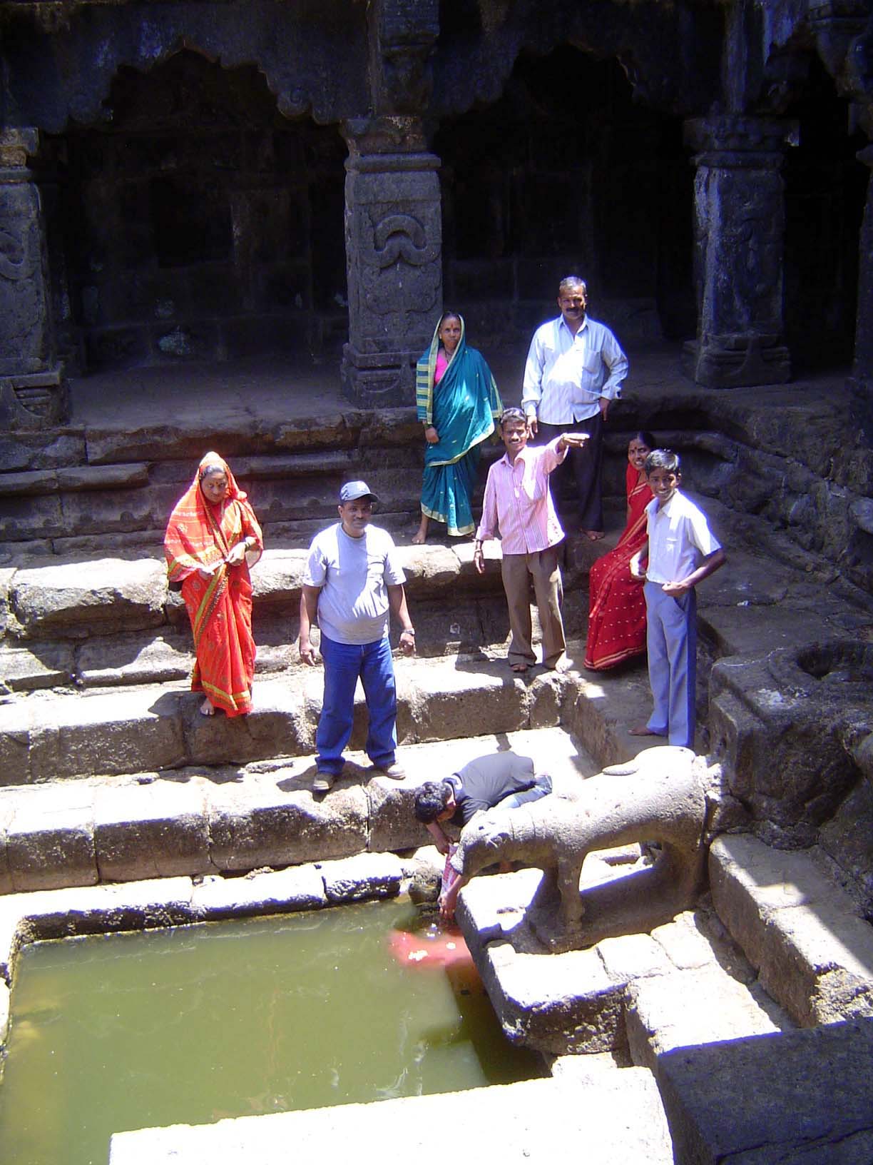Even in the dry weather, a few people come by to say a prayer and collect a bit of water.