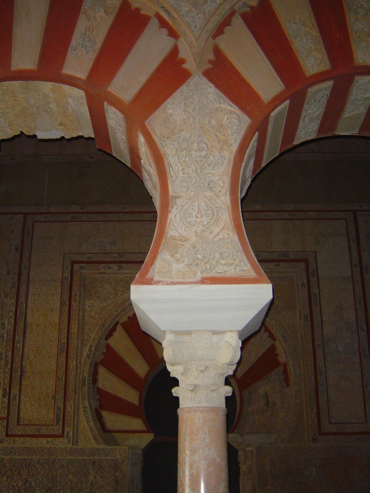 The columns support well-developed horseshoe arches and polychrome or ablaq voissoirs./P