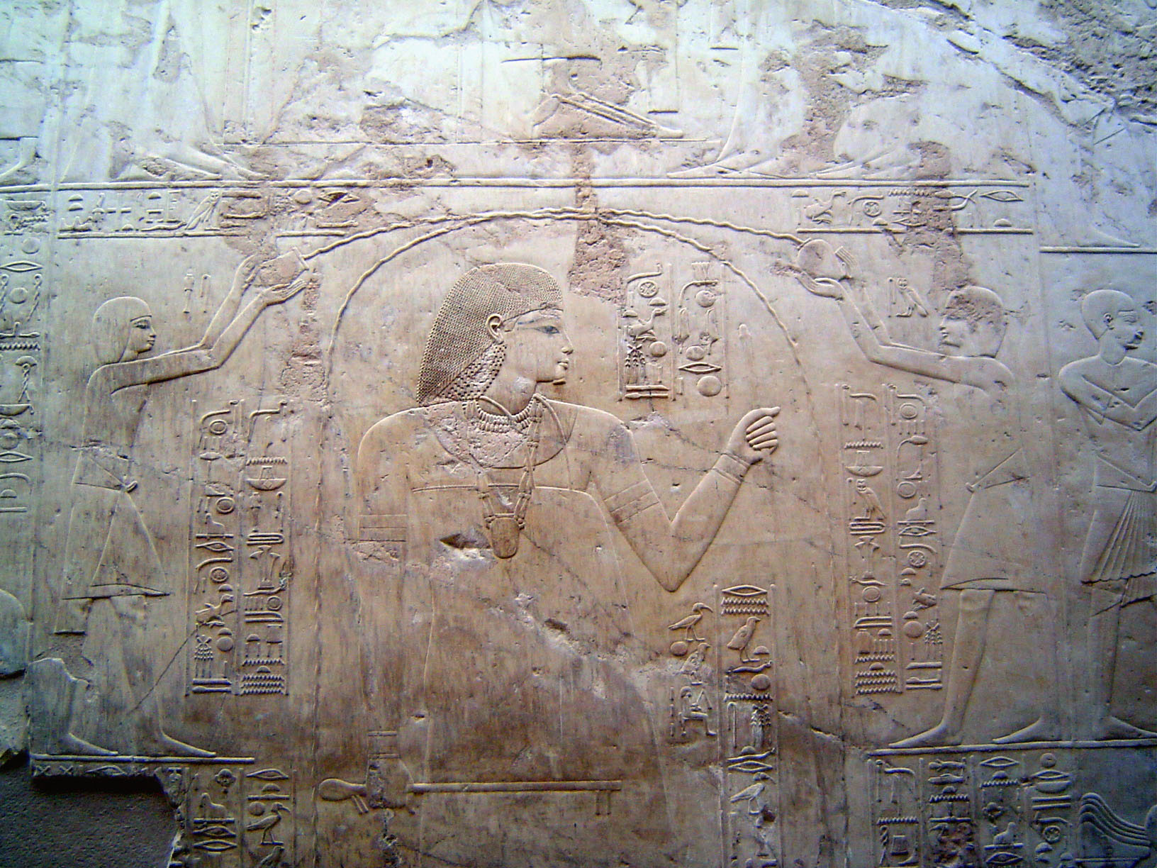 Ramose died young, and the walls were never painted. Still, they were carved to perfection. Here, priests pour purifying water over Ramose,