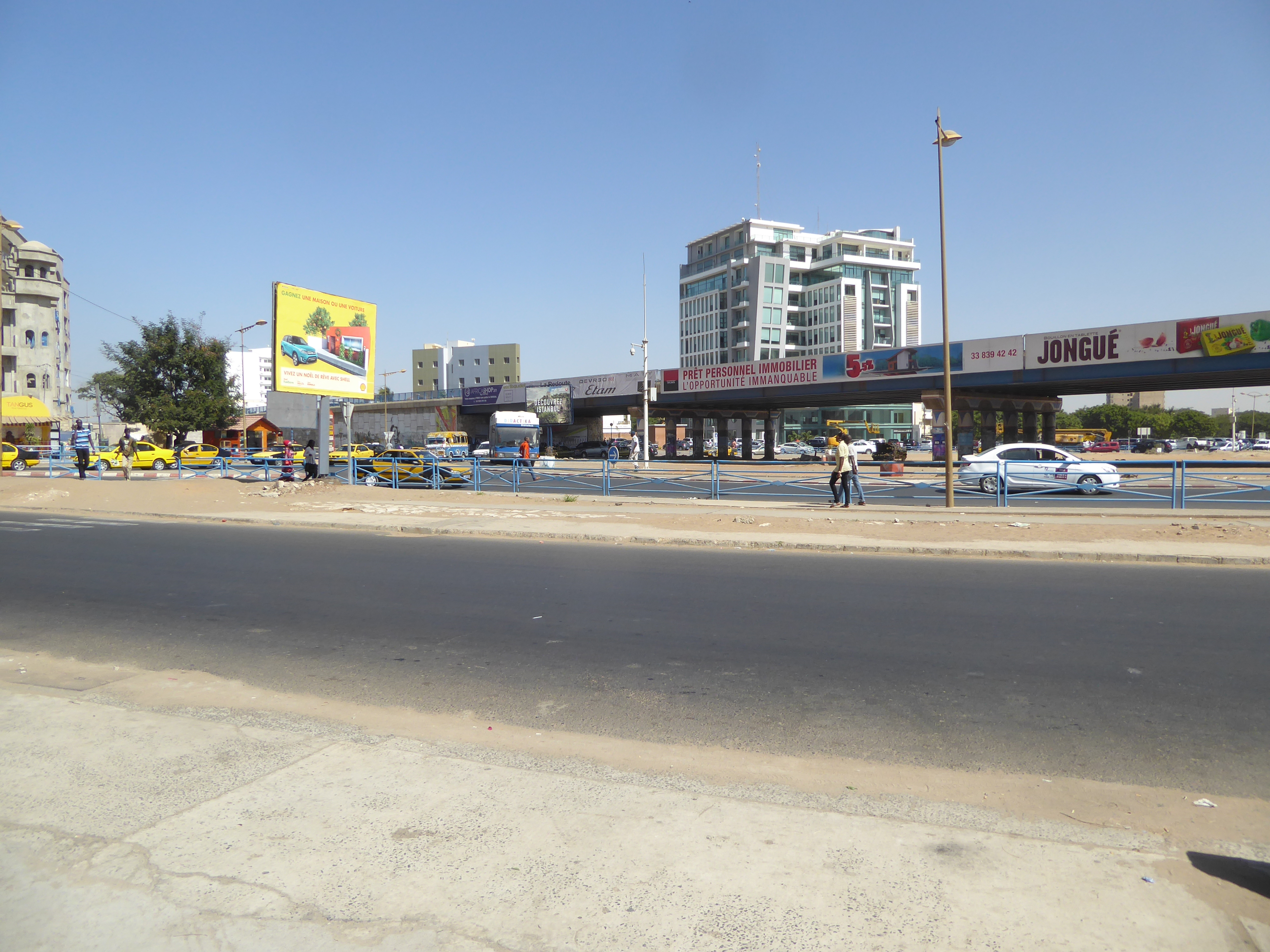 Keep walking inland and you approach the contemporary city, spread-out enough to require highways and overpasses. The advertisements include