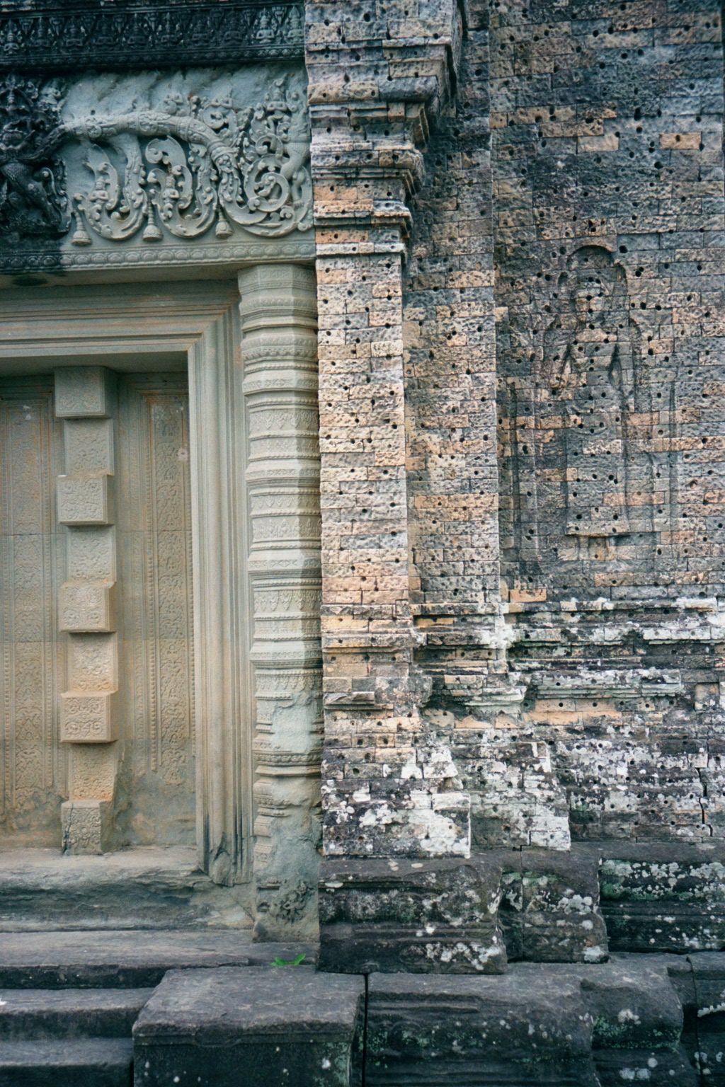 Here's one of the blocked doors. The holes in the brickwork on the right are original, intended to anchor the stucco that once covered the b