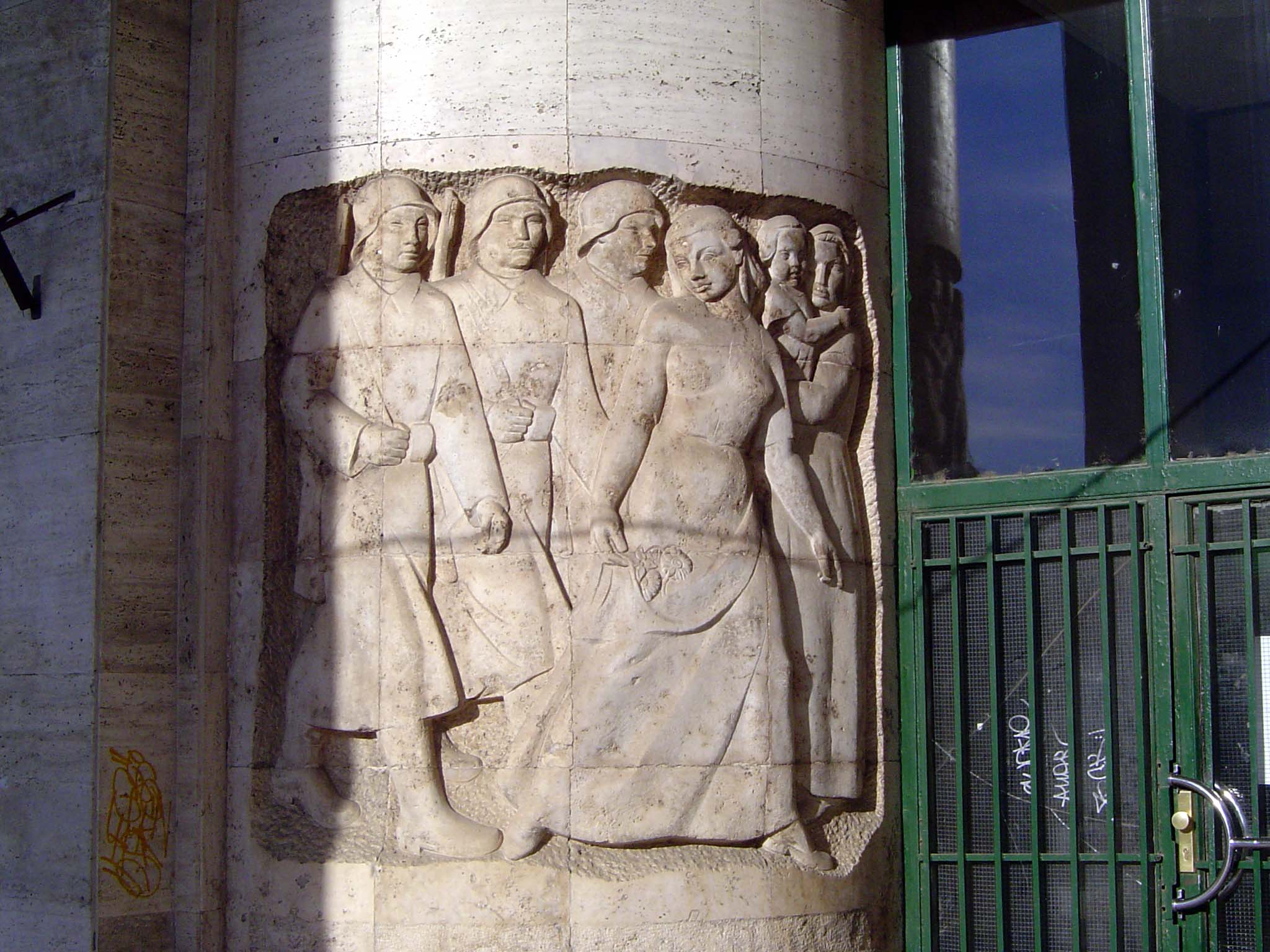 A relief on the wall of the building suggests a fondness for brute strength.