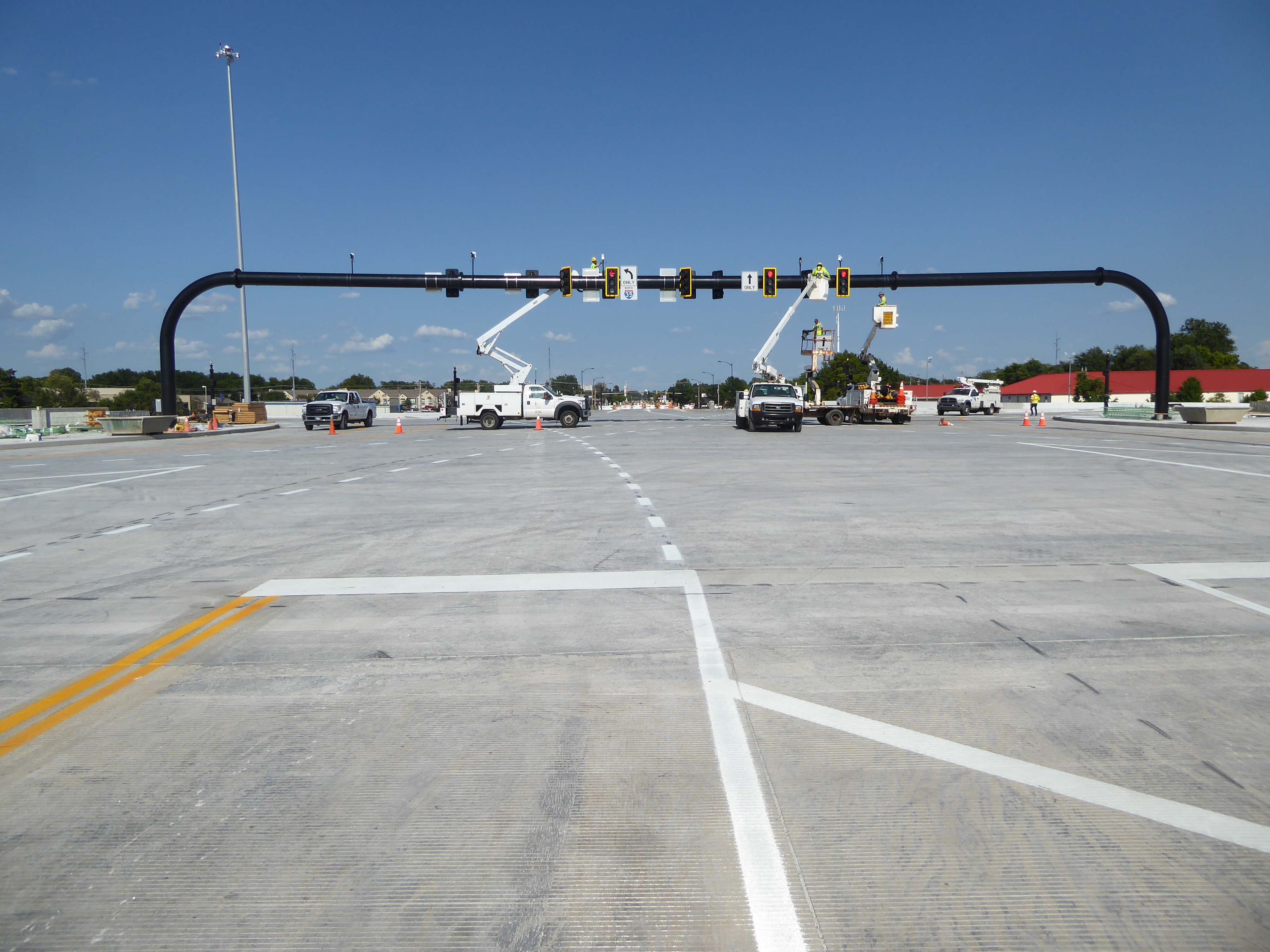 What does a growing town need? Why, what else but new freeway interchanges. Here's a splendid single-point interchange the day before its gr
