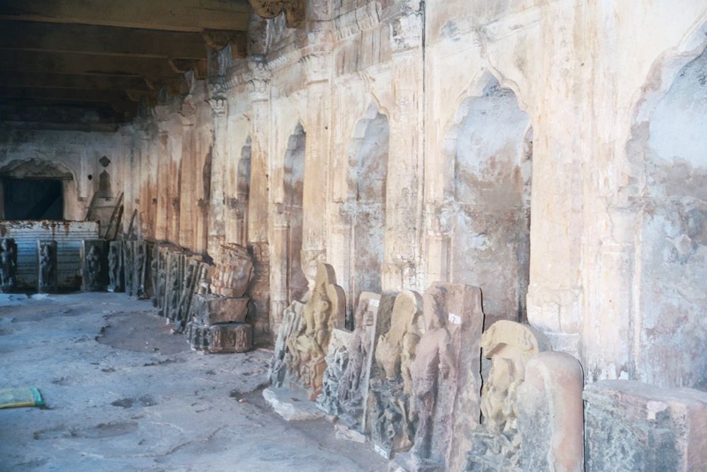 Under the arcade, decorative slabs in storage.