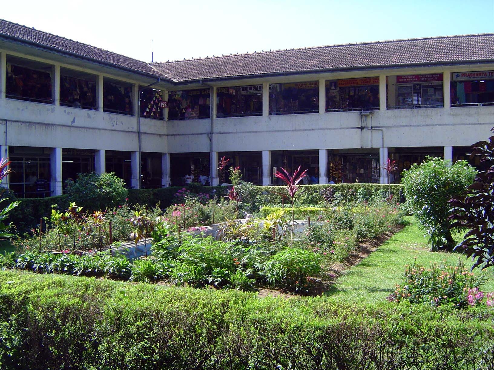 The market stalls wrap around a surprisingly well-cared-for patio garden.