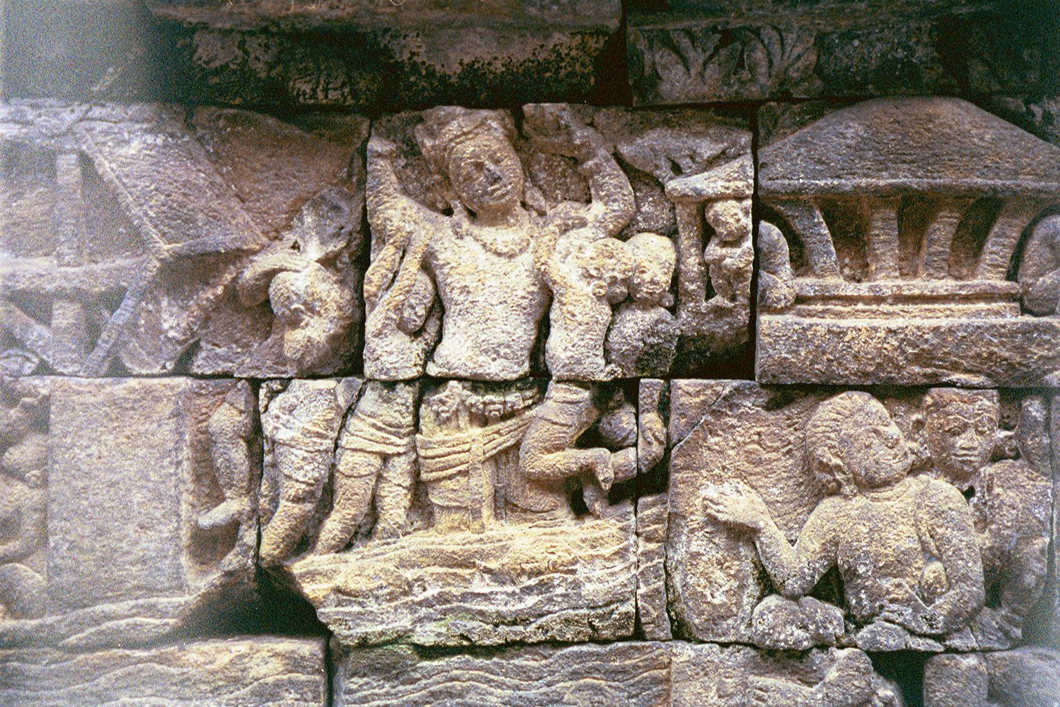 On the fourth level balustrade, Maitreya's generous actions are shown. Here, he carries people across a river.