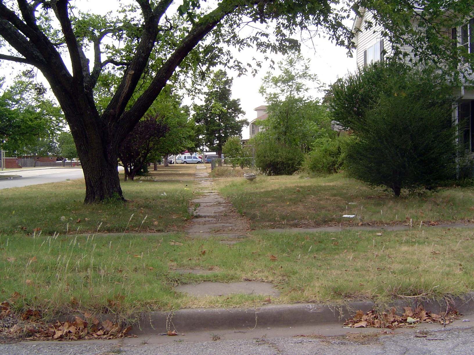 The commercial buildings have been replaced, but some older features remain, like this sidewalk.