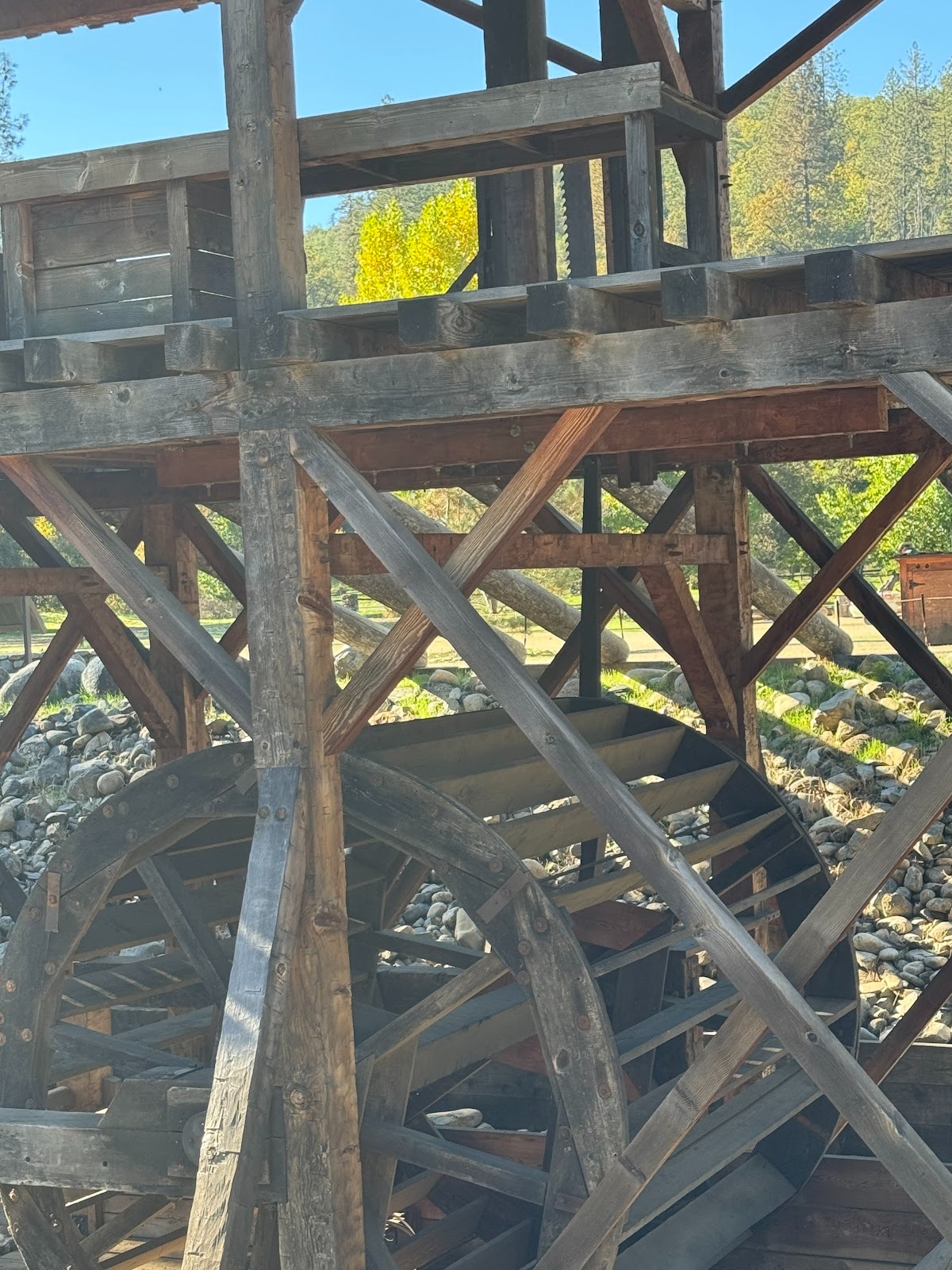 Look carefully and you can make out the saw blade driven by a crank on the far side of the wheel.
