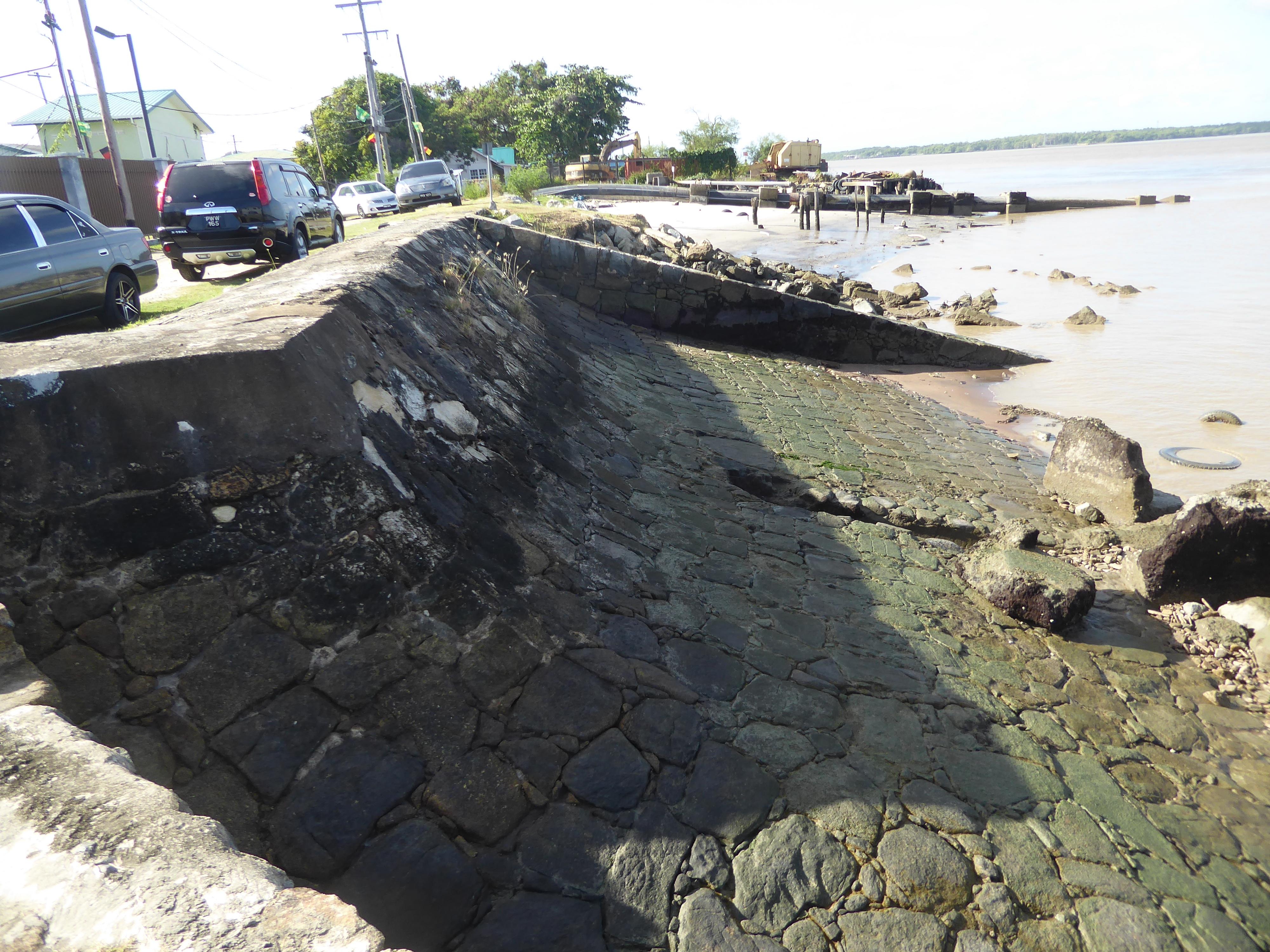Construction of the sea wall began in the 1850s with convict labor placing blocks of granite floated down from quarries on the Mazaruni, a t