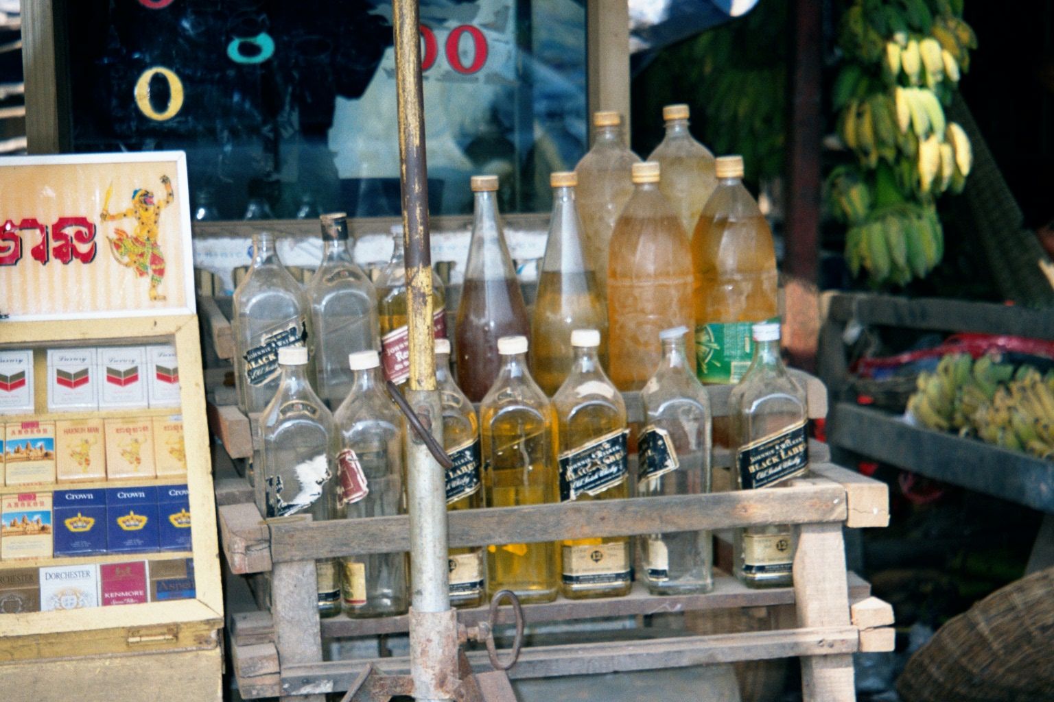 The Cambodians themselves shop in a market at the northeast corner of town. Here, in old whiskey bottles, is fuel for their motor scooters.